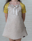 Girl's Beige Quilted A-Line Dress with Hand Embroidered Raglan Sleeves - Swati Golyan